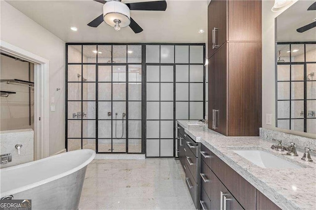 bathroom featuring vanity, a tub, and tile walls