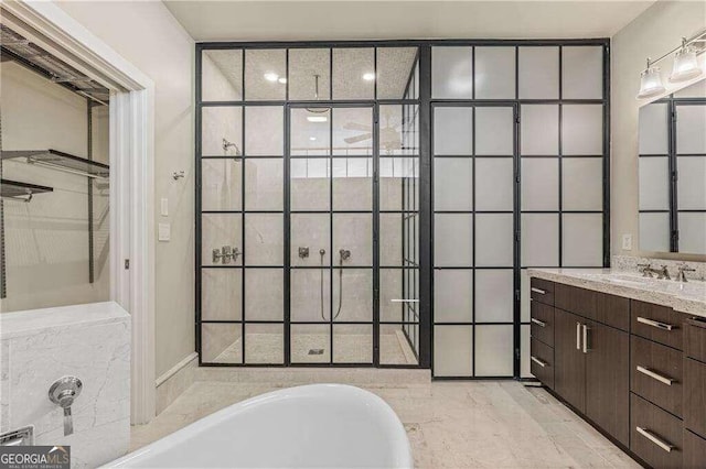 bathroom with a washtub and vanity