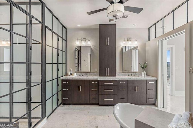 bathroom featuring a tub, ceiling fan, and vanity