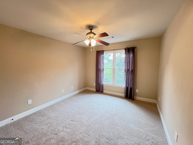 carpeted spare room with ceiling fan