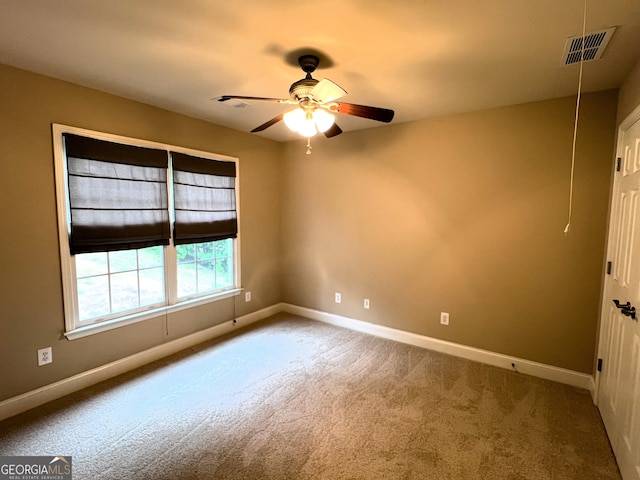 spare room with carpet and ceiling fan