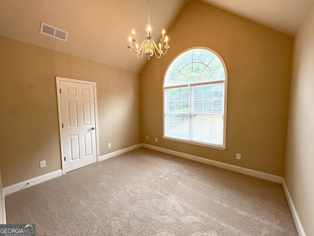 empty room featuring carpet, vaulted ceiling, and an inviting chandelier