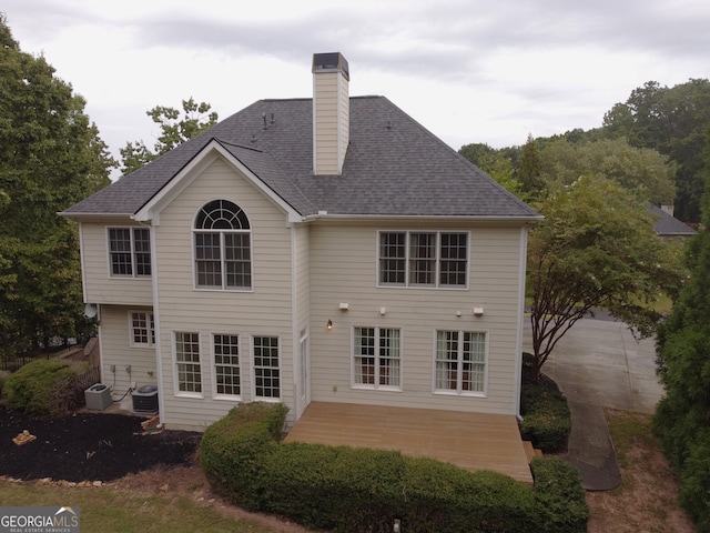 back of house with central AC unit