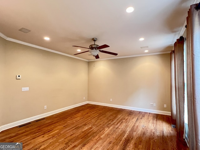 spare room with dark hardwood / wood-style floors, ceiling fan, and ornamental molding