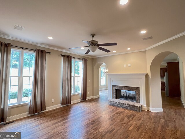 unfurnished living room featuring a fireplace, hardwood / wood-style flooring, a wealth of natural light, and ceiling fan