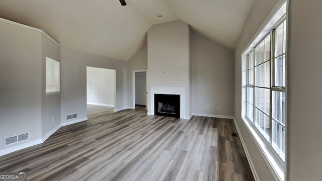 unfurnished living room with high vaulted ceiling, light wood-type flooring, and ceiling fan