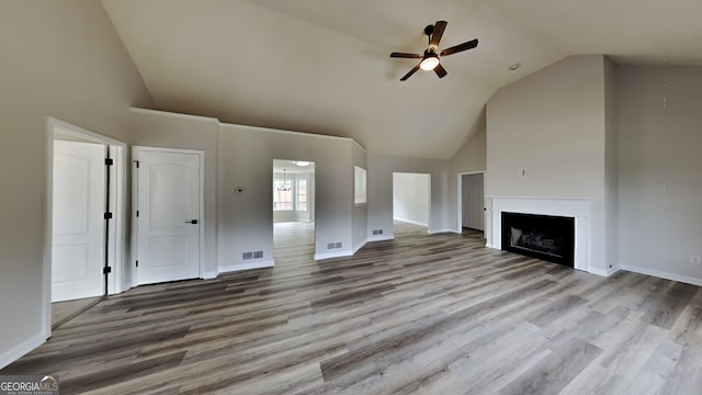 unfurnished living room featuring high vaulted ceiling, light hardwood / wood-style flooring, and ceiling fan