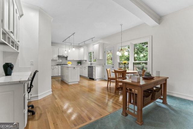 dining room with ornamental molding, beam ceiling, and light wood-type flooring