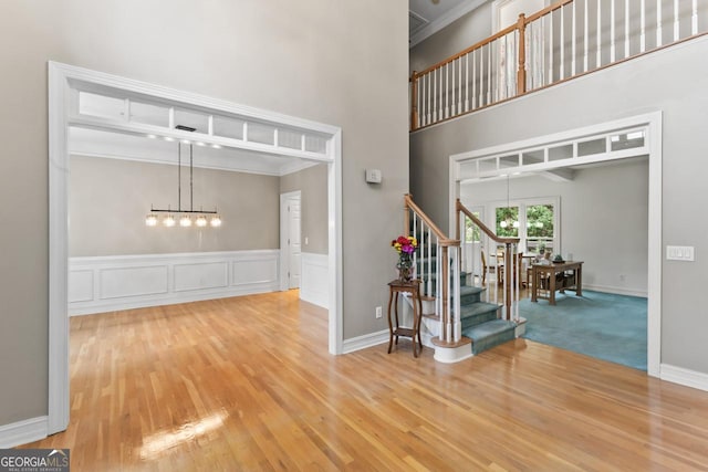 foyer entrance with hardwood / wood-style floors and a high ceiling