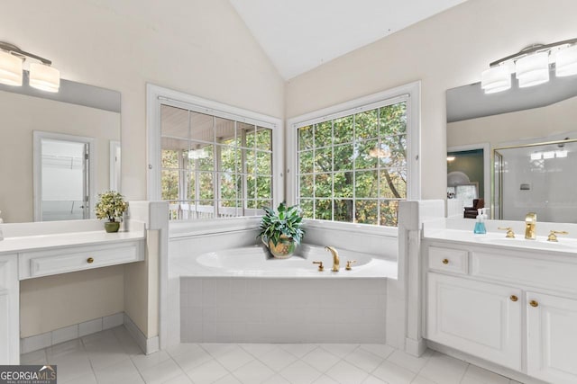 bathroom with tile patterned floors, vanity, plus walk in shower, and vaulted ceiling