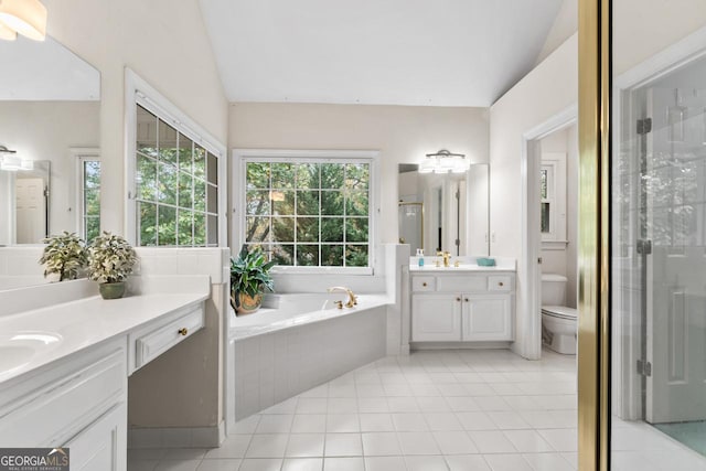 full bathroom featuring vaulted ceiling, independent shower and bath, vanity, toilet, and tile patterned floors