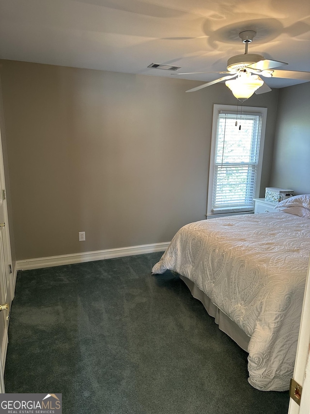 bedroom with ceiling fan and dark carpet