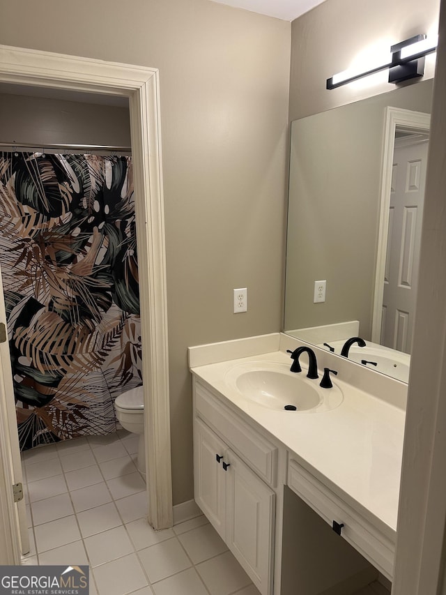 bathroom with tile patterned floors, vanity, and toilet