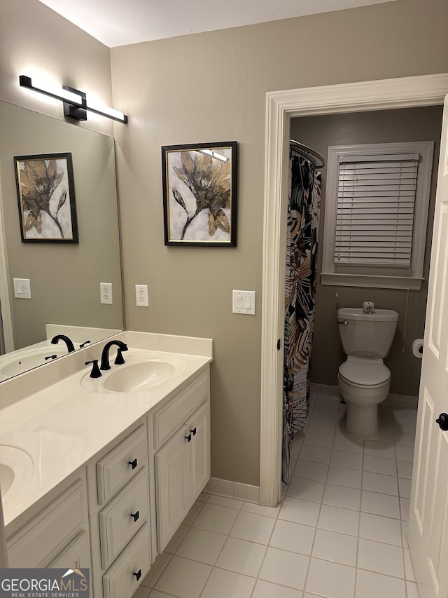 bathroom with vanity, tile patterned floors, and toilet