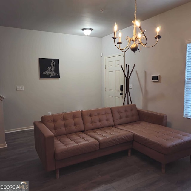 living room featuring dark hardwood / wood-style floors and a chandelier