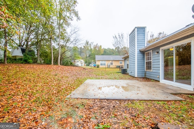 view of yard with central AC and a patio area