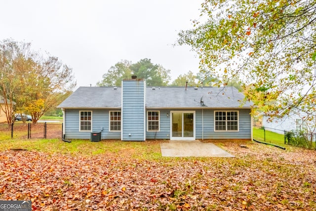 rear view of property featuring central air condition unit and a patio