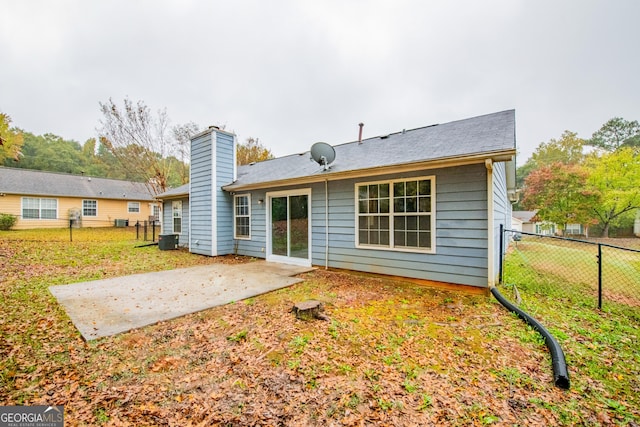 1121 Whisper Wind Dr, Mcdonough, GA 30253 - rear view of property featuring a patio and a chimney