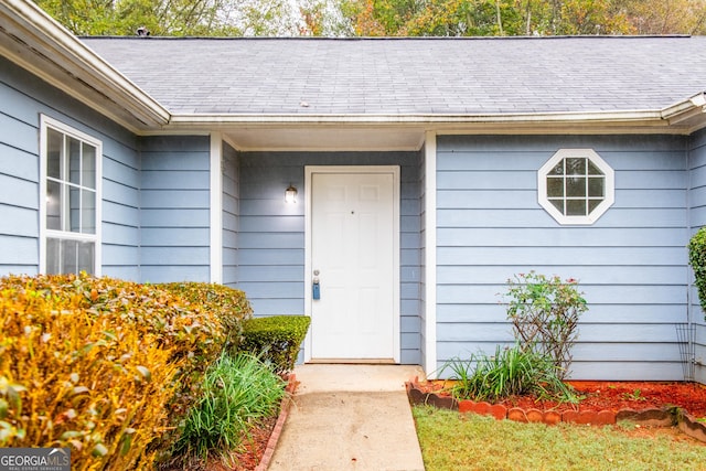 1121 Whisper Wind Dr, Mcdonough, GA 30253 - view of exterior entry featuring roof with shingles