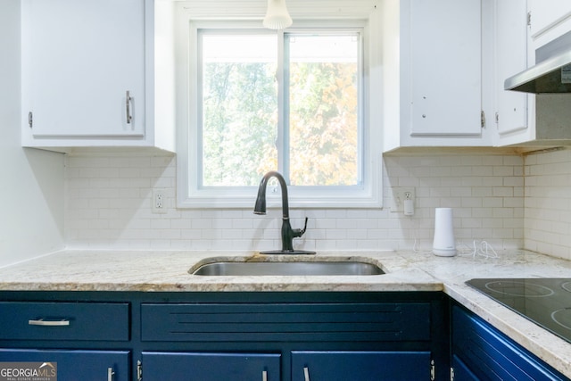 kitchen featuring white cabinets, blue cabinetry, and plenty of natural light