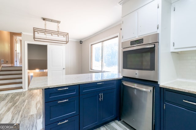 kitchen with stainless steel appliances, kitchen peninsula, hanging light fixtures, blue cabinetry, and white cabinets