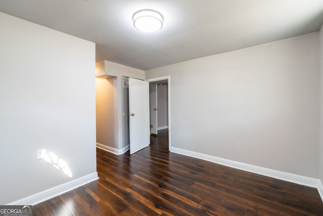 spare room with dark hardwood / wood-style flooring