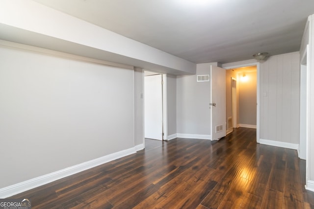 basement with dark hardwood / wood-style floors