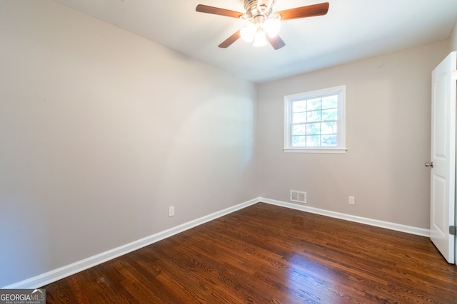 spare room with dark hardwood / wood-style flooring and ceiling fan