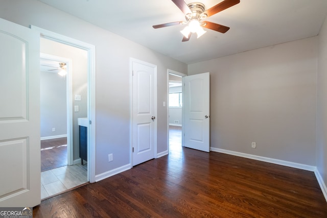 unfurnished bedroom featuring dark wood-type flooring and ceiling fan