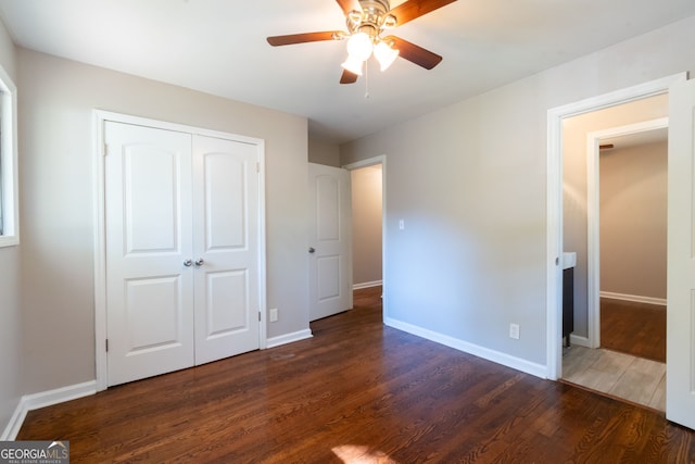 unfurnished bedroom with a closet, ceiling fan, and dark hardwood / wood-style floors