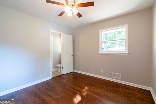 spare room with ceiling fan and dark hardwood / wood-style flooring