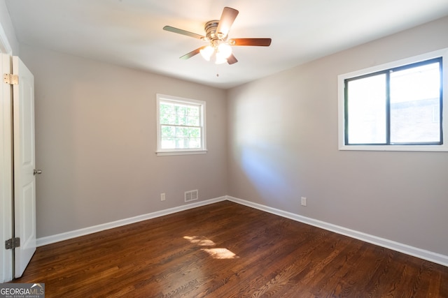 unfurnished room featuring ceiling fan and dark hardwood / wood-style floors