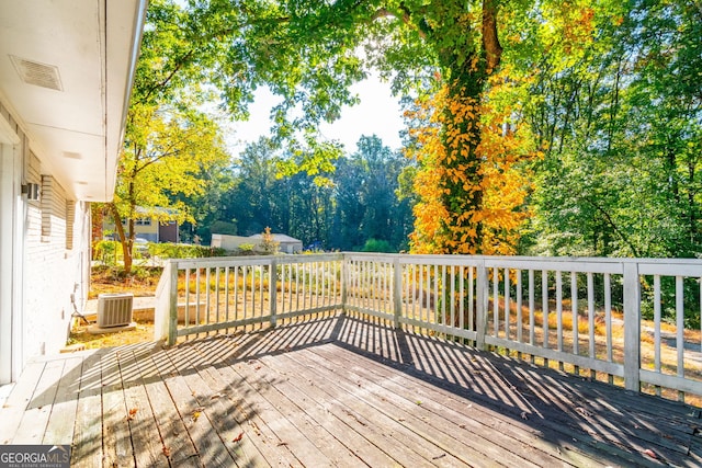 wooden deck featuring cooling unit