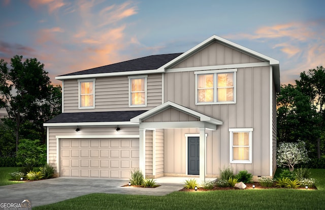 view of front of home with a garage and a lawn