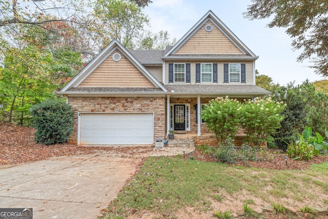 craftsman house featuring a garage, a porch, and a front lawn