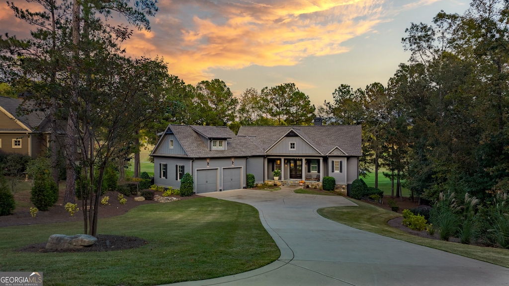 view of front of property featuring a garage and a yard