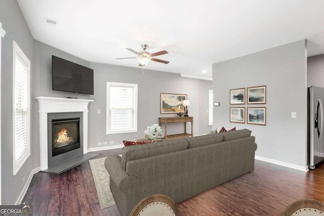 living room featuring dark hardwood / wood-style flooring and ceiling fan