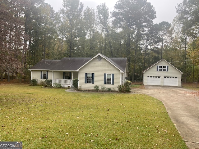 ranch-style home with an outbuilding, a garage, a front yard, and a porch