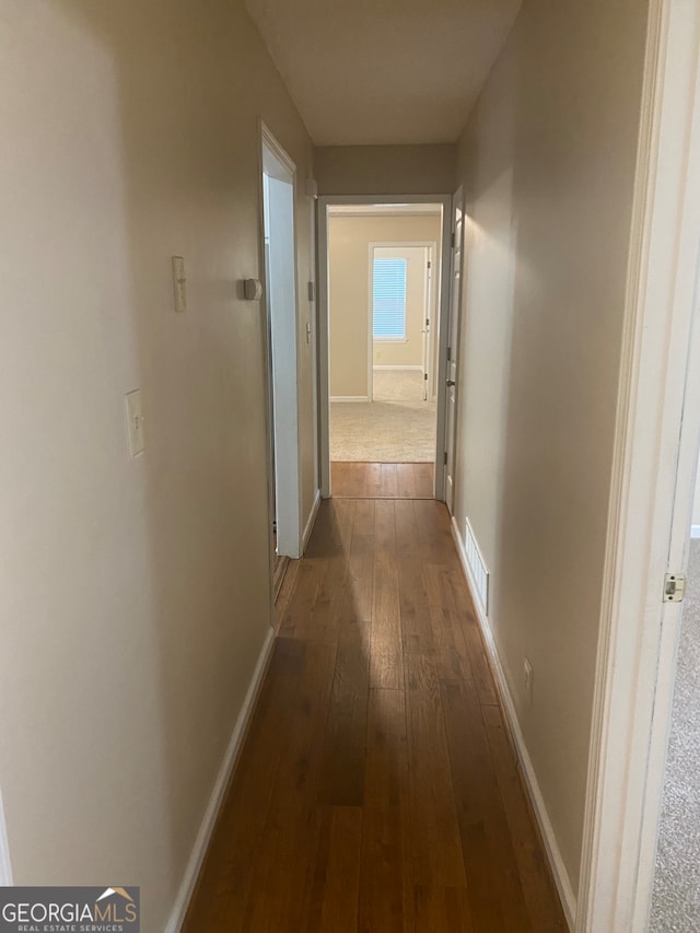 corridor featuring dark hardwood / wood-style flooring