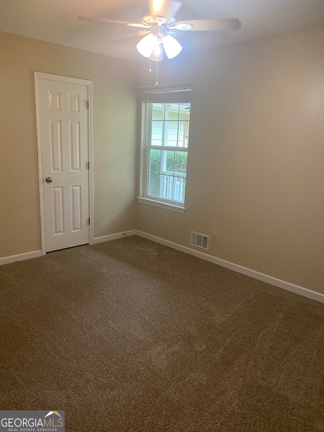 carpeted empty room with ceiling fan