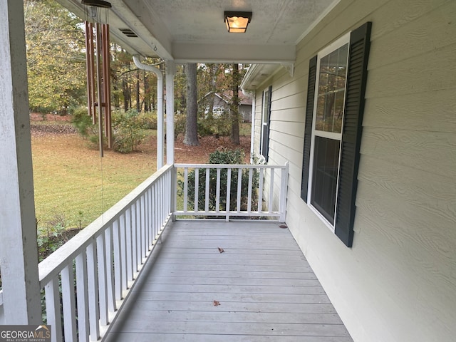 wooden terrace featuring covered porch