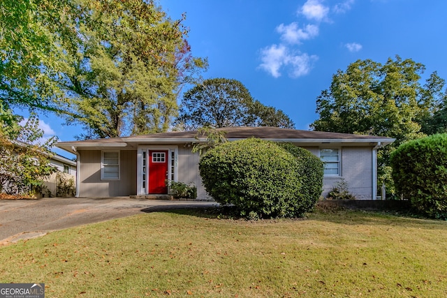 single story home with a front lawn and a carport