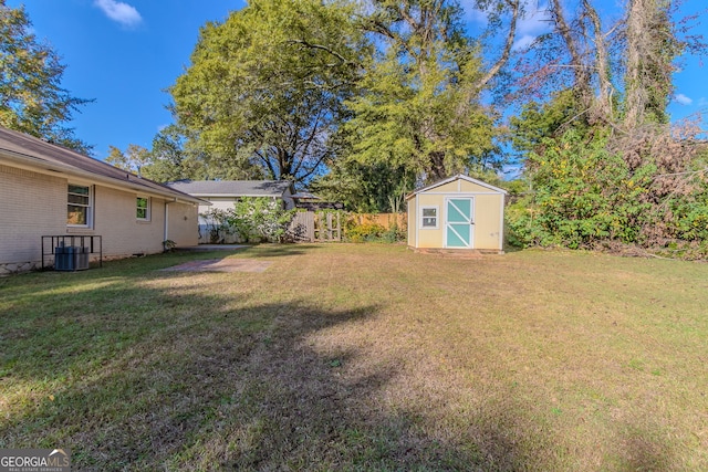 view of yard with central AC and a shed