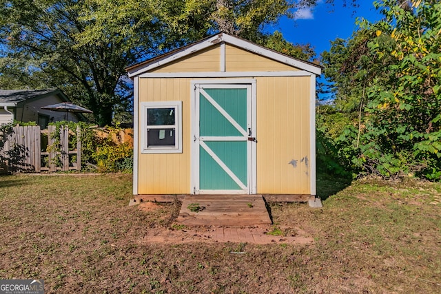 view of outbuilding with a lawn