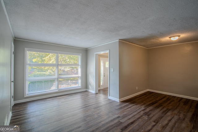 spare room with dark hardwood / wood-style flooring, a textured ceiling, and crown molding