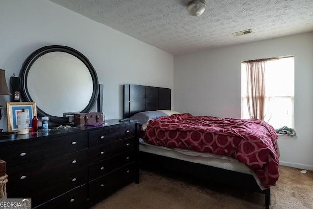 carpeted bedroom with a textured ceiling