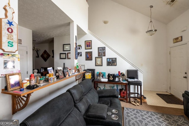 carpeted living room with a textured ceiling and vaulted ceiling