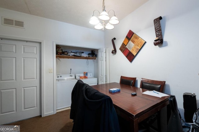 dining area featuring a textured ceiling, dark colored carpet, separate washer and dryer, and a chandelier