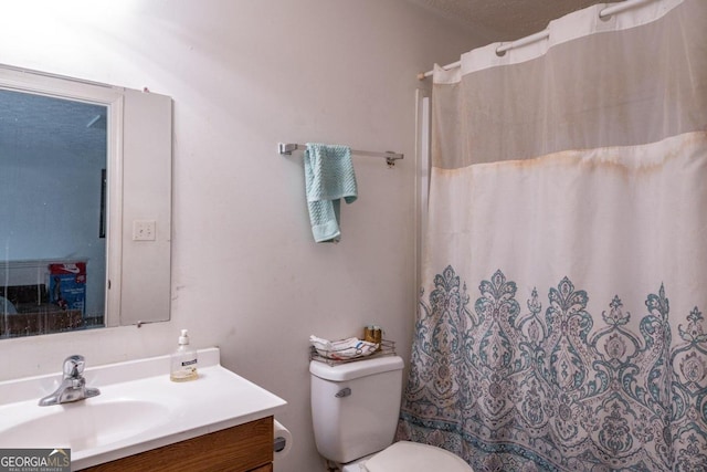 bathroom with toilet, vanity, a shower with shower curtain, and a textured ceiling