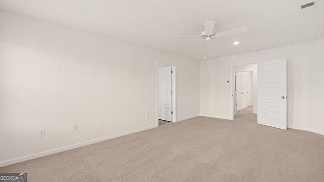 carpeted empty room featuring ceiling fan